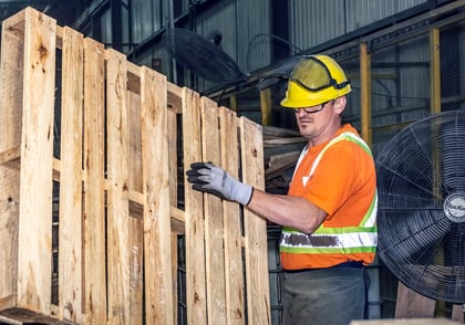 Paramount pallet employee moving recycled wooden pallet